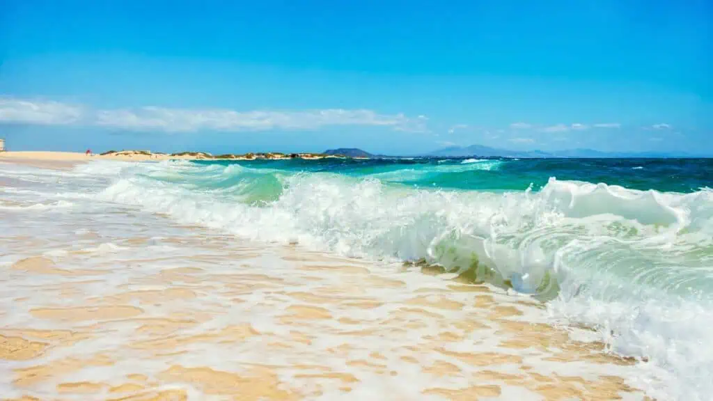 Waves, sea, sand and blue sky at Flag Beach Corralejo Fuerteventura